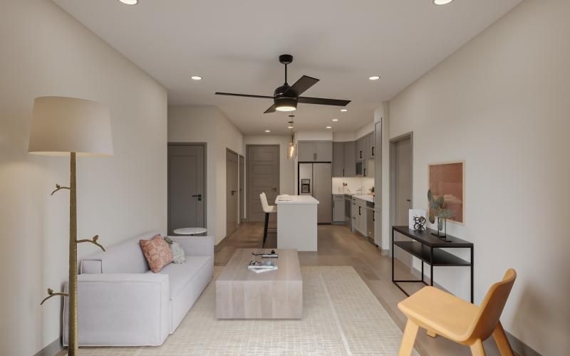 a living room with a white couch and a white table