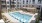 a swimming pool in a courtyard between buildings
