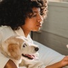 girl reading book with dog