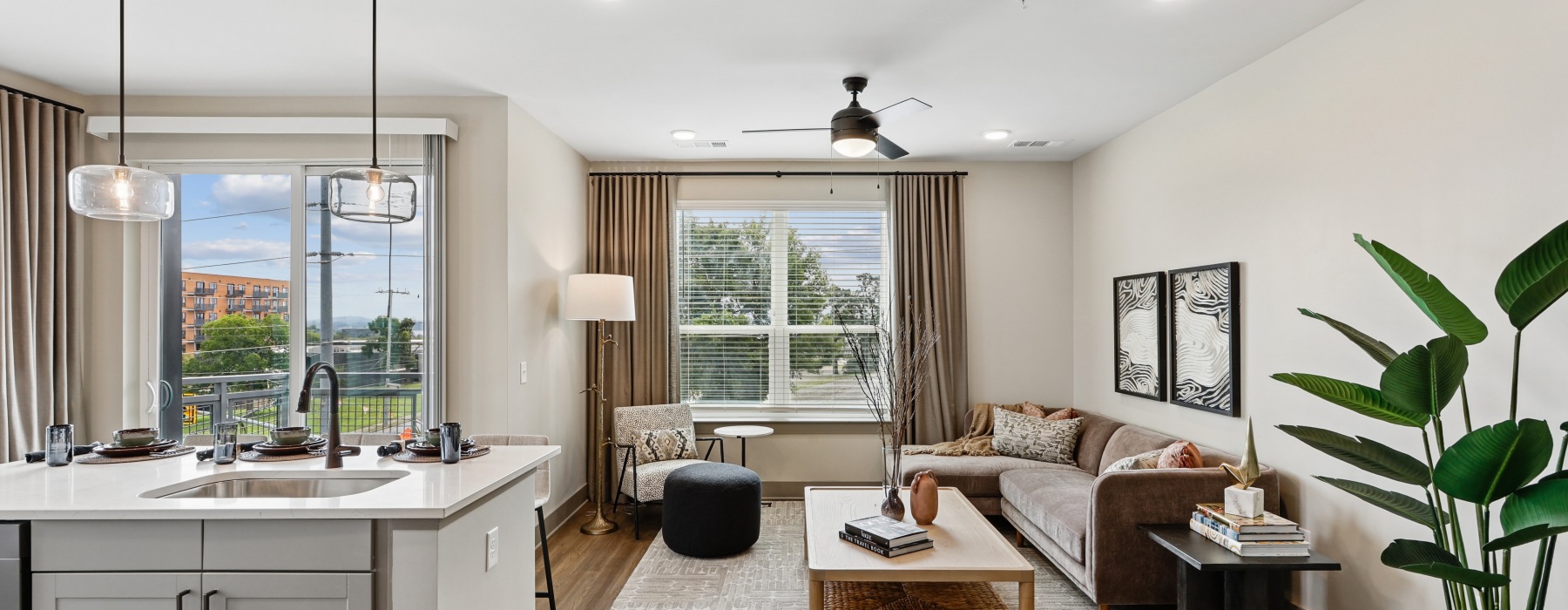 living room with large windows and kitchen island