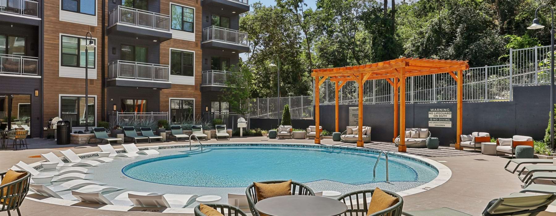 swimming pool with pergola and lounge chairs