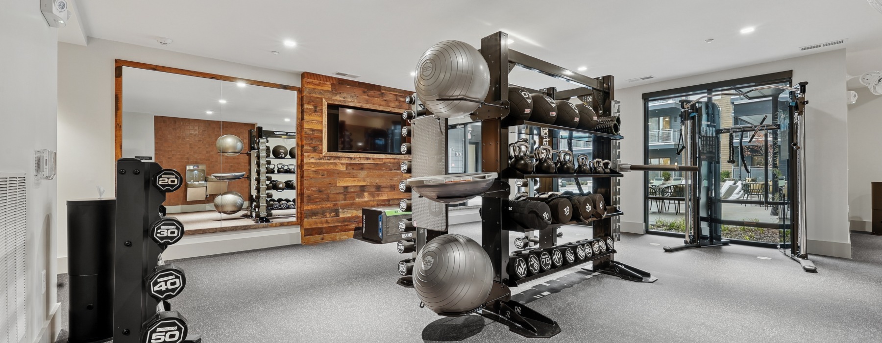 fitness center with weights, pilates equipment and treadmills