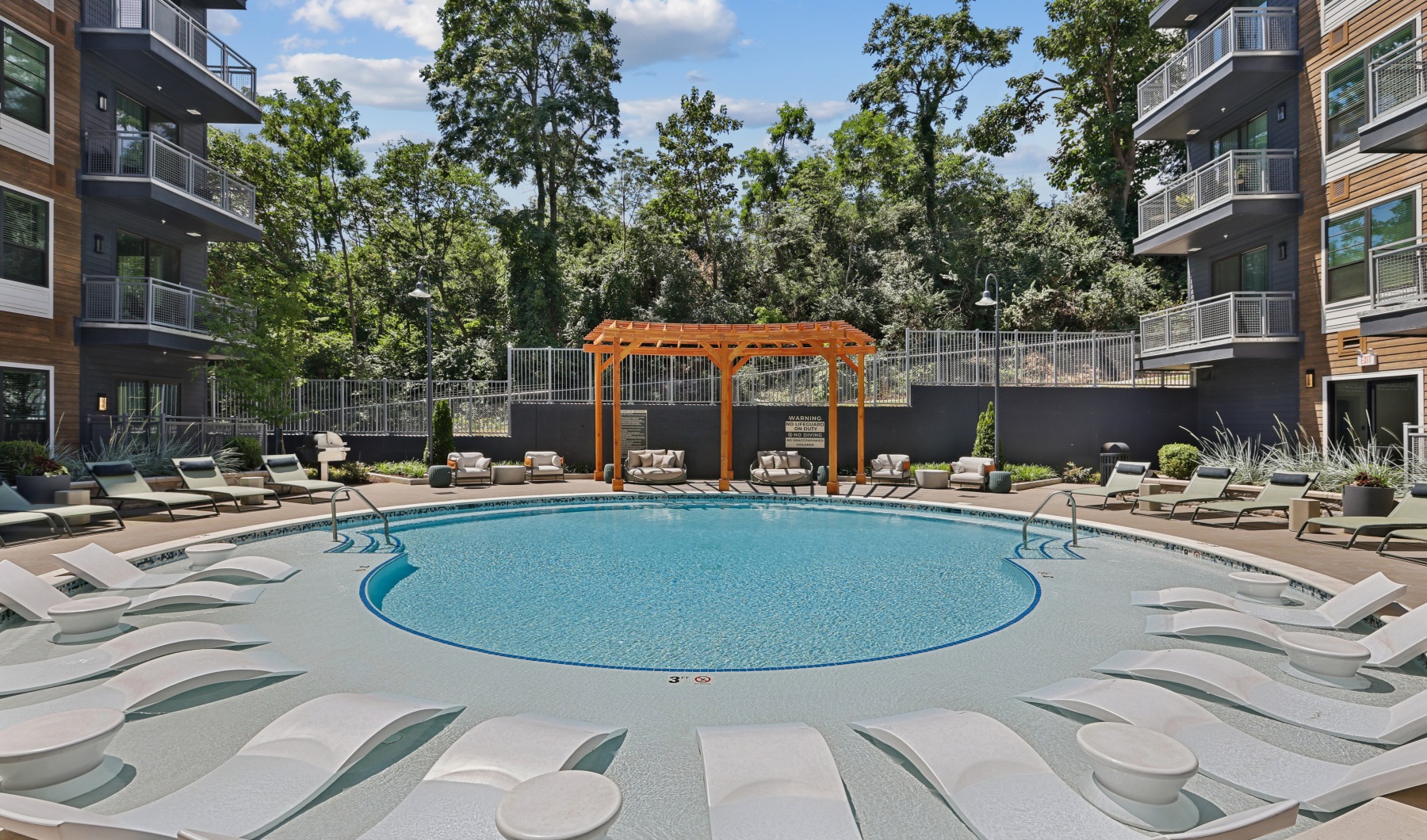 round swimming pool with lounge chairs