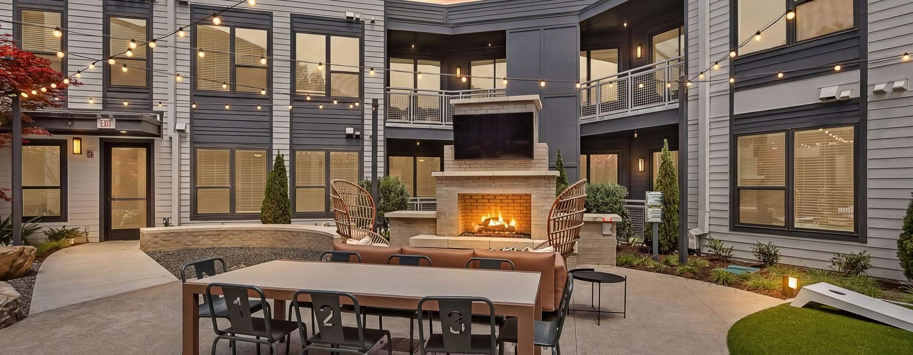 outdoor courtyard with outdoor fire place and dining table with chairs